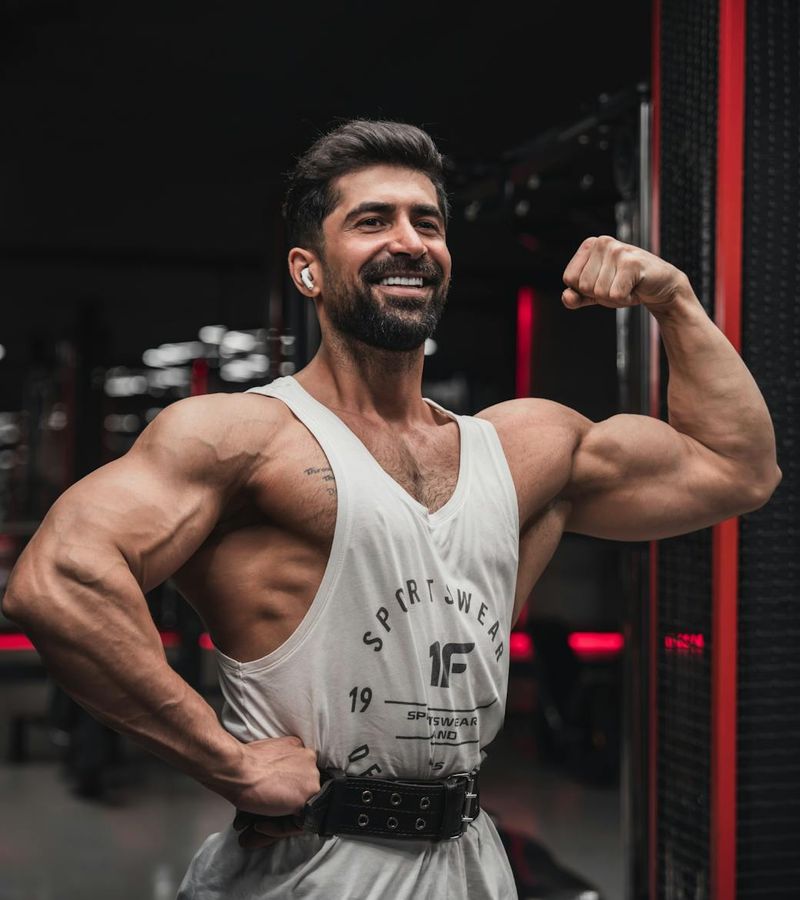 Man performing a powerful strength exercise in a modern, minimalist gym.
